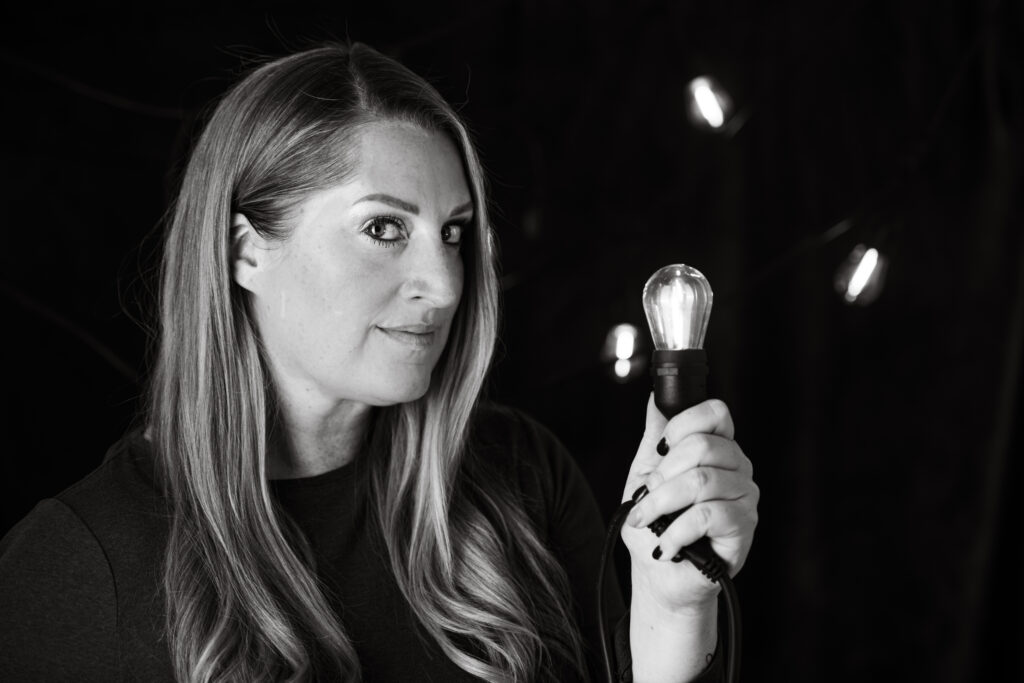 Anne Gillaspie holding a light bulb to inspire and create