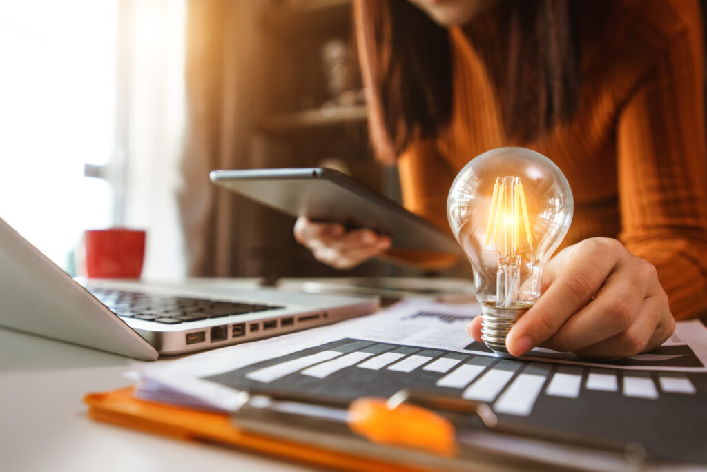 business hand showing creative business strategy with light bulb as concept