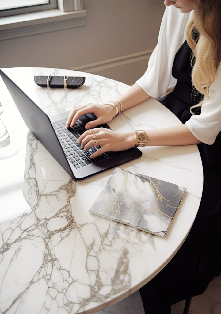 a woman working with her laptop at the table