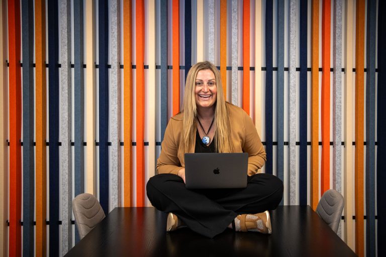 Anne Gillespie, owner of Fix & Form, sitting with her laptop in the Denver office, representing branding and website strategy expertise.