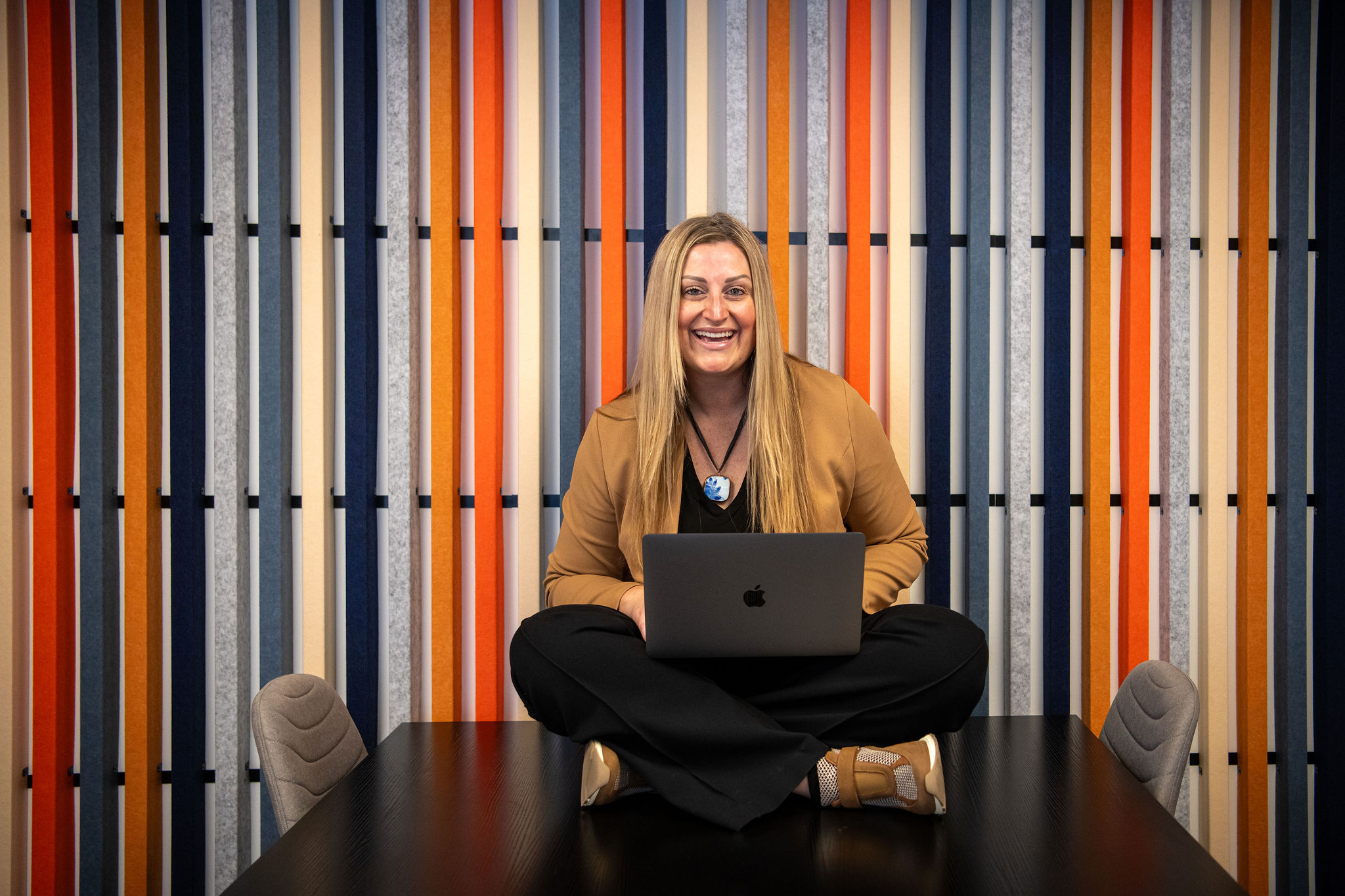 Anne Gillespie, owner of Fix & Form, sitting with her laptop in the Denver office, representing branding and website strategy expertise.