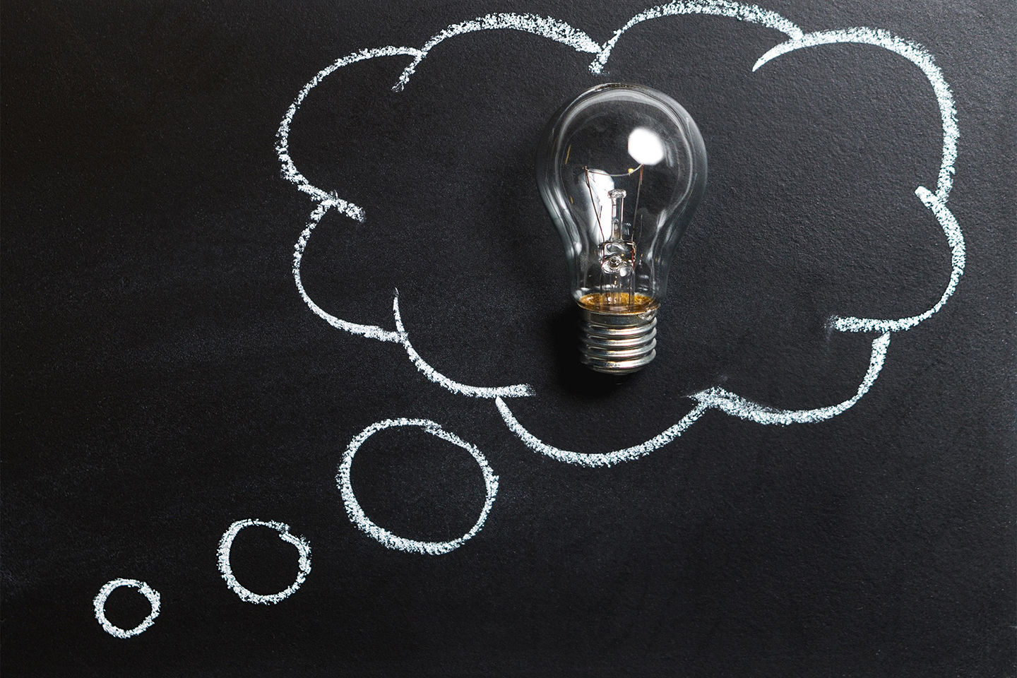 A lightbulb inside a chalk-drawn thought bubble symbolizing creative strategy and the bright ideas behind every Fix & Form branding project.