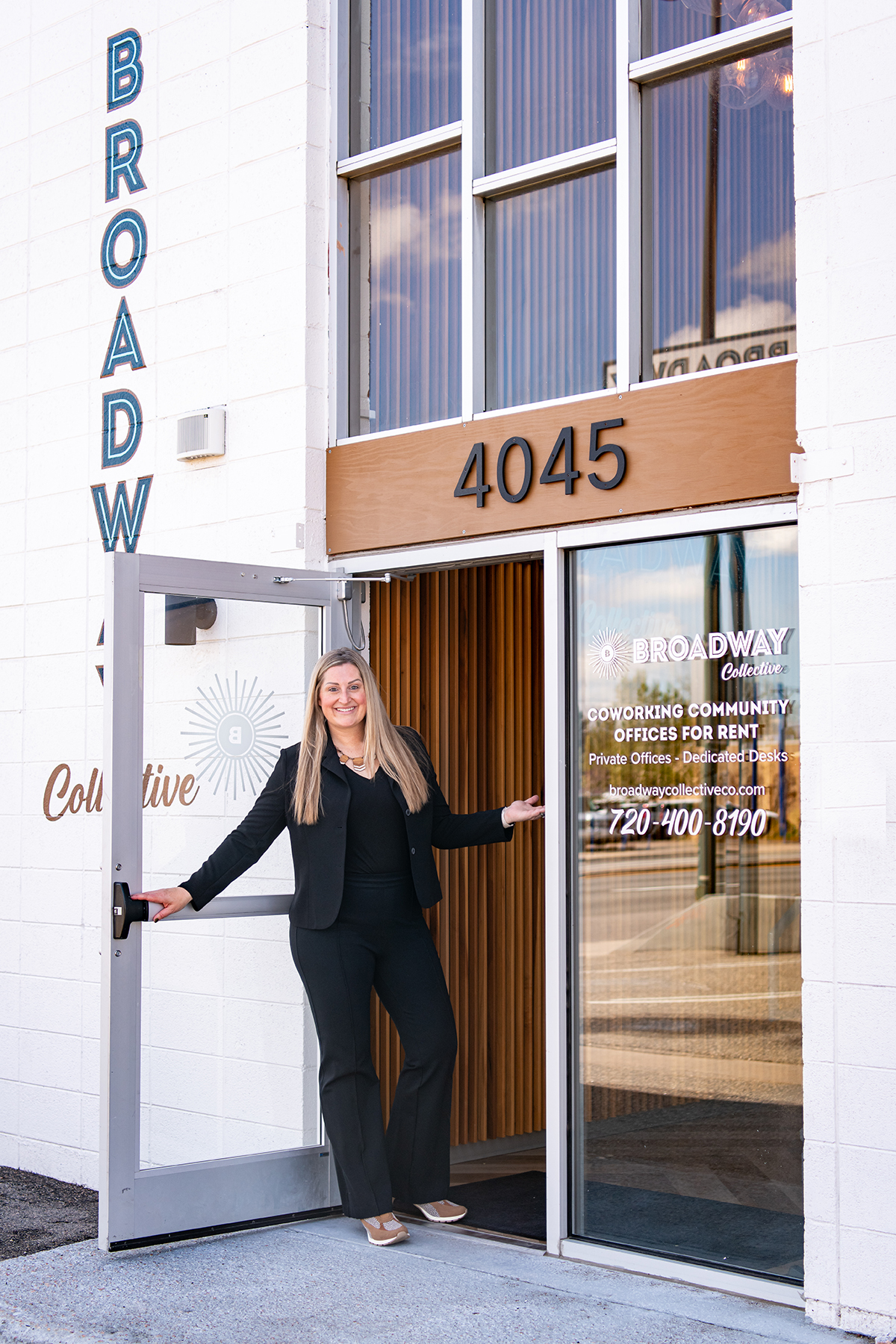 Anne Gillaspie, Denver brand strategist and founder of Fix & Form, standing at the entrance of the Broadway Collective office building and welcoming clients.