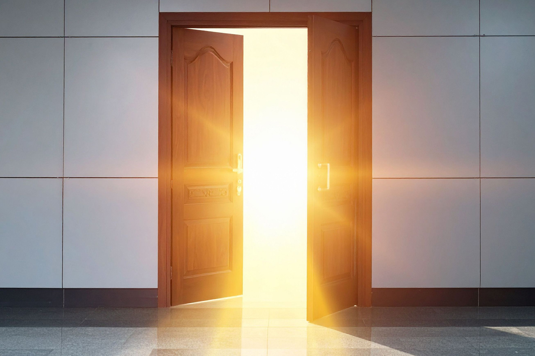 Open doorway filled with bright light, symbolizing transformation, clarity, and moving forward through strategic brand story realignment.