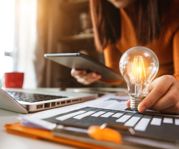 business hand showing creative business strategy with light bulb as concept
